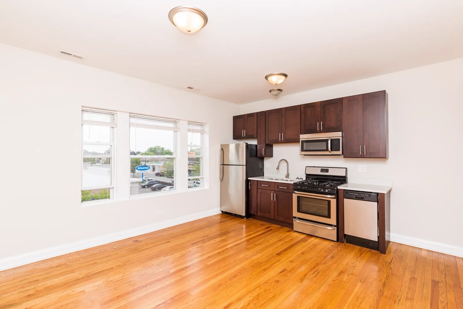 Open living area and kitchen with hardwood floors