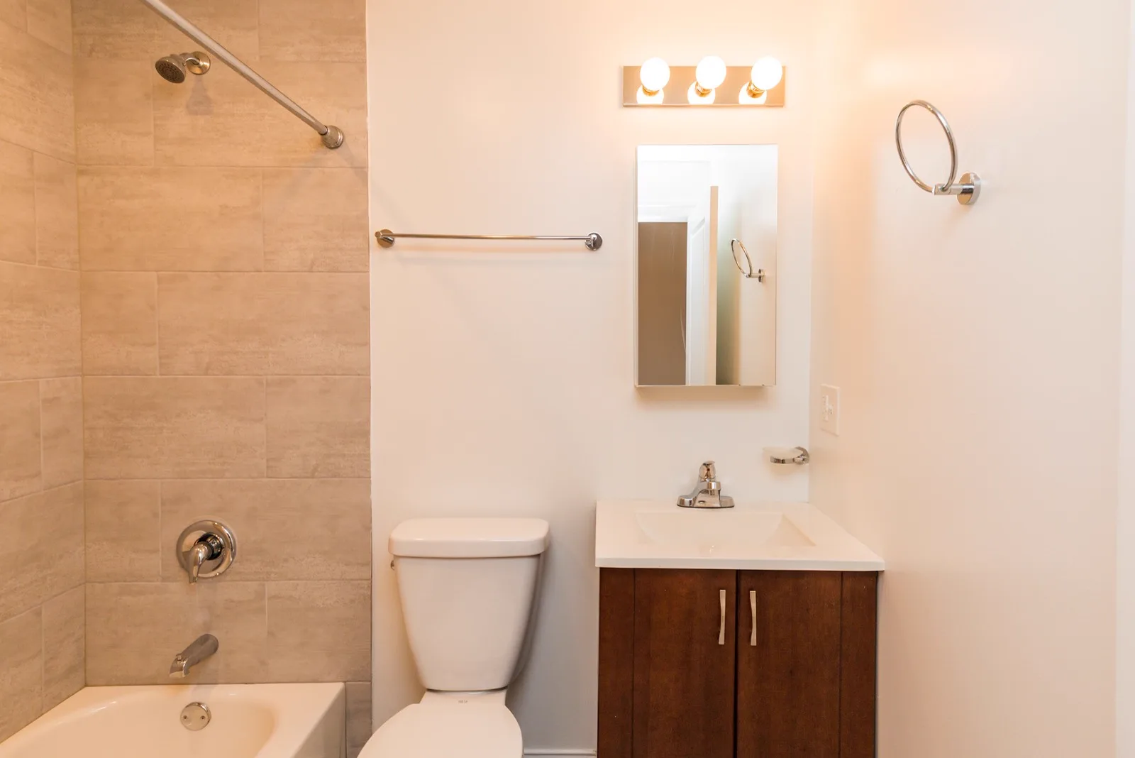 New bathroom with tiled tub surround and vanity