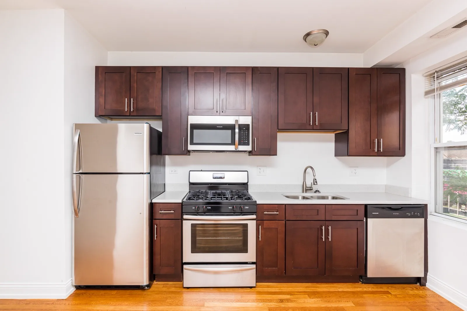 Kitchen with cherry cabinets, granite countertops and stainless steel appliances
